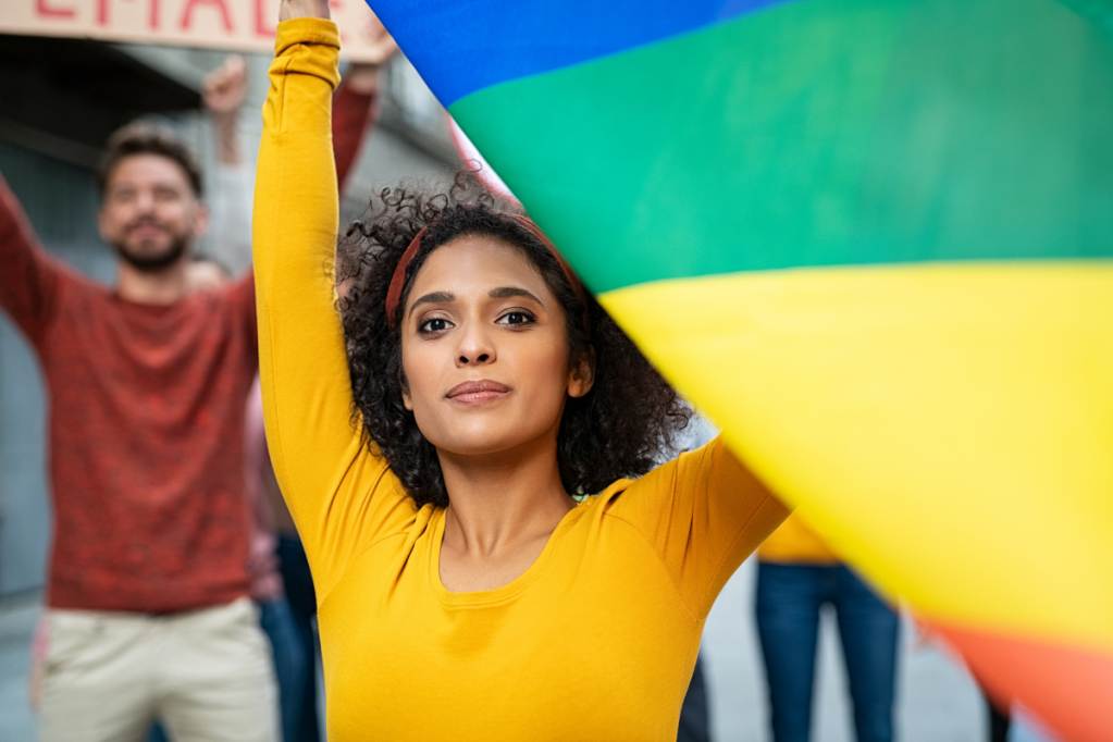 Woman looking confident with rainbow flag
